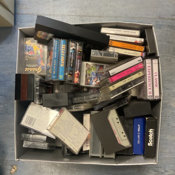 Assorted vintage cassette tapes in a mixed lot for collectors.