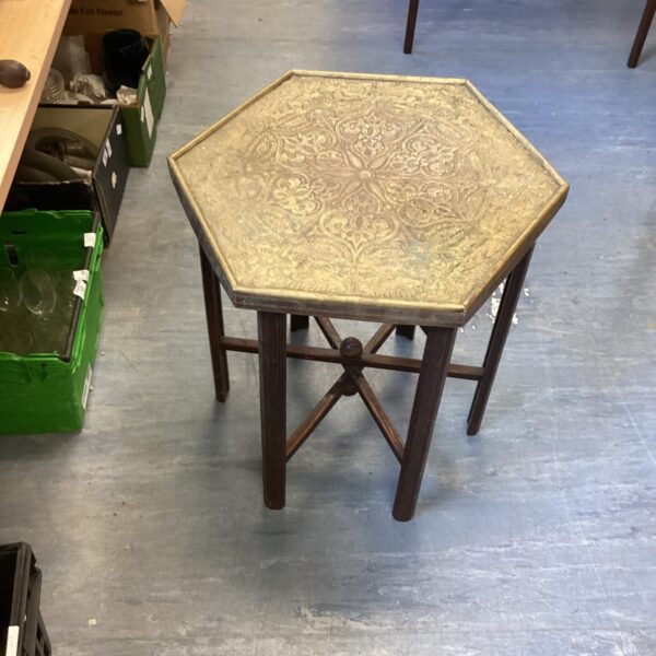 Antique Indian gate leg table with detailed copper top.