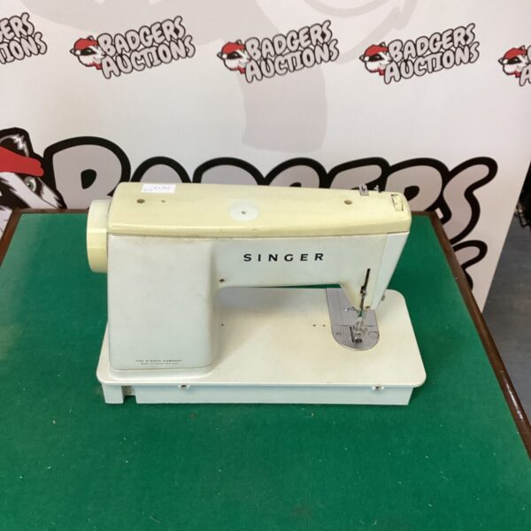 Vintage Singer electric sewing machine in used condition.