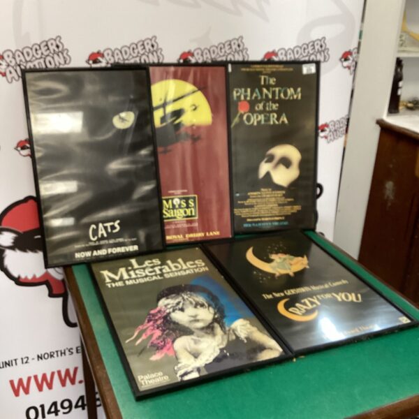 Framed musical poster collection featuring Cats, Les Misérables, and Phantom.