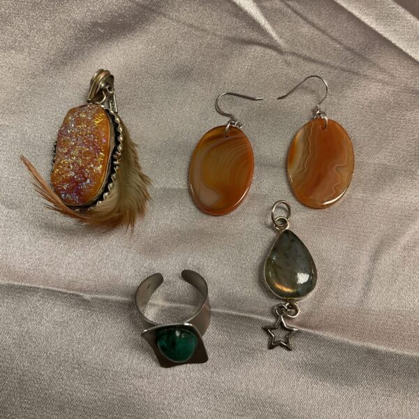 Close-up of a stone jewellery lot with earrings, pendants and a ring.