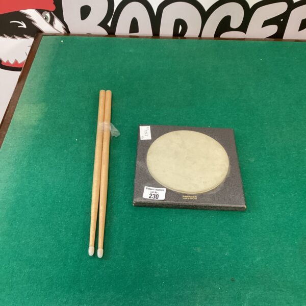 Premier drum pad with Percy Prior drum sticks for silent practice.