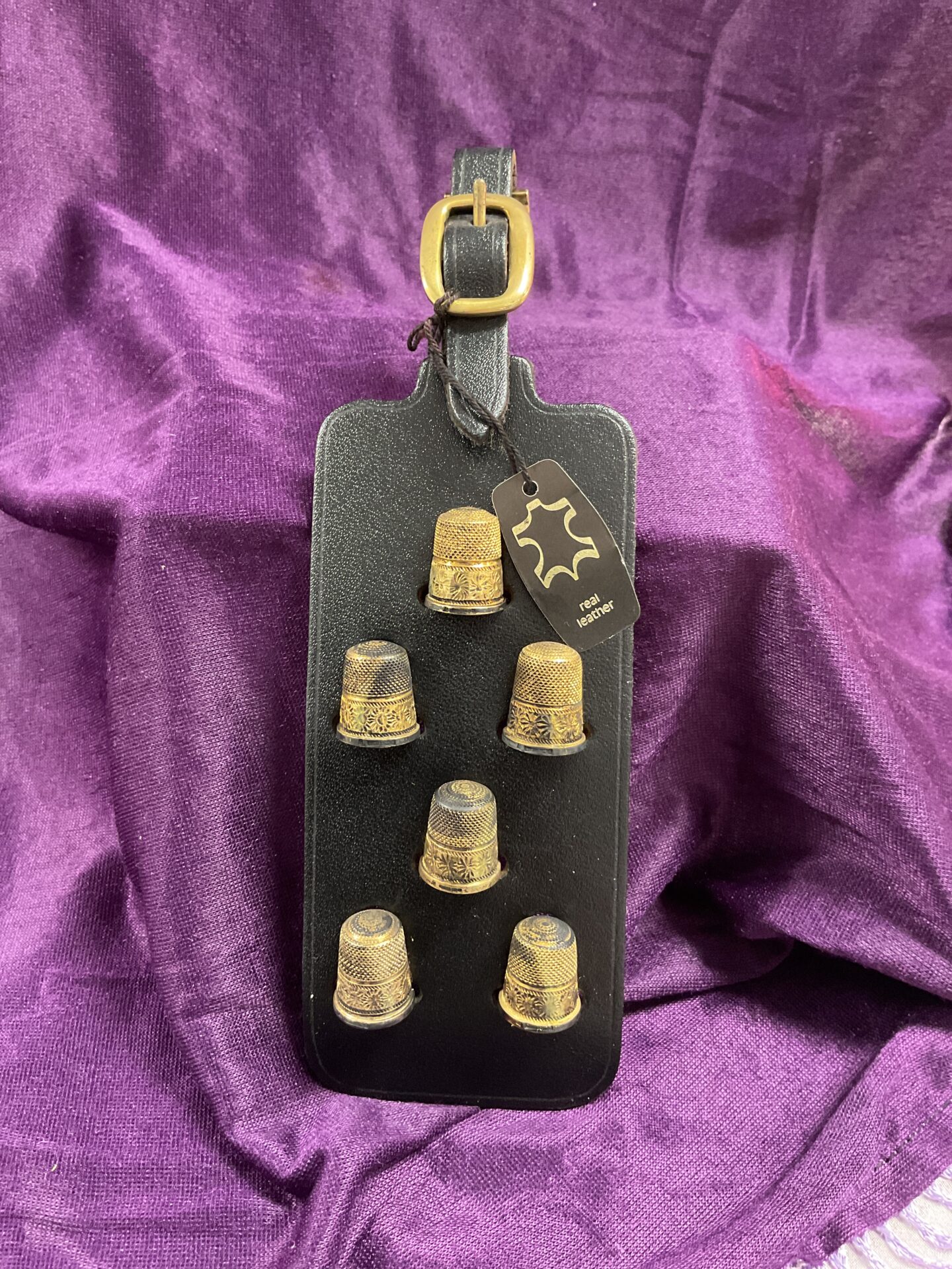 790 Six Hallmarked Sterling Silver Thimbles on Leather Strap