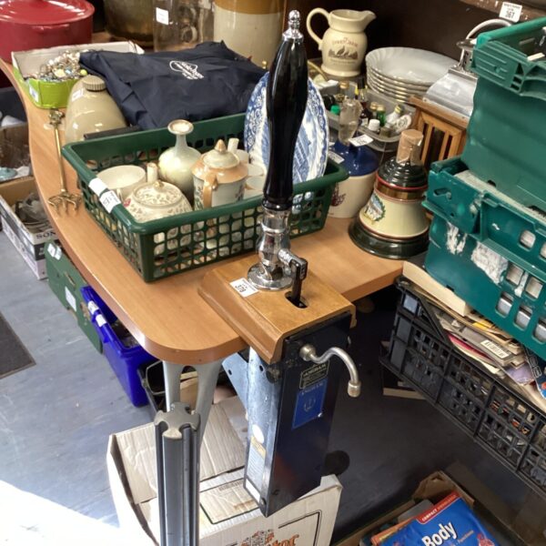 Vintage brass Anagram beer pump mounted on a wooden surface.