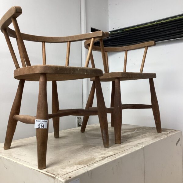 Vintage wooden arm chairs for children, rustic seating.