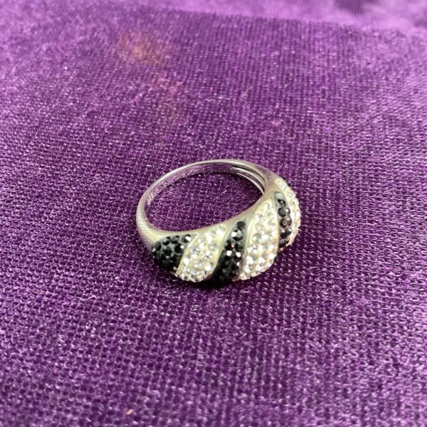 Silver ring with black and white stones, size N.