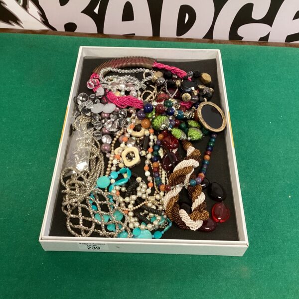 Tray of colourful costume jewellery necklaces and beaded fashion accessories.