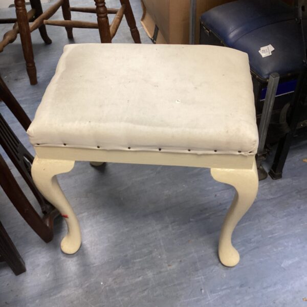 Cream upholstered vintage dressing table stool with curved legs.