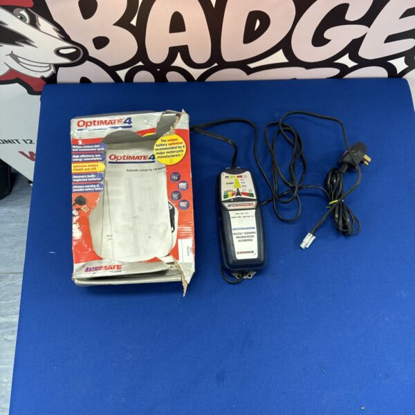 Optimate 4 battery charger in original box, showing features.