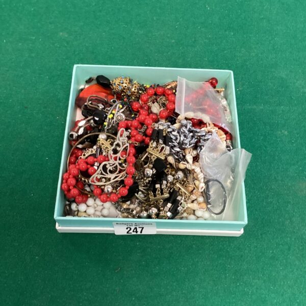 Close-up view of colourful vintage costume jewellery pieces.