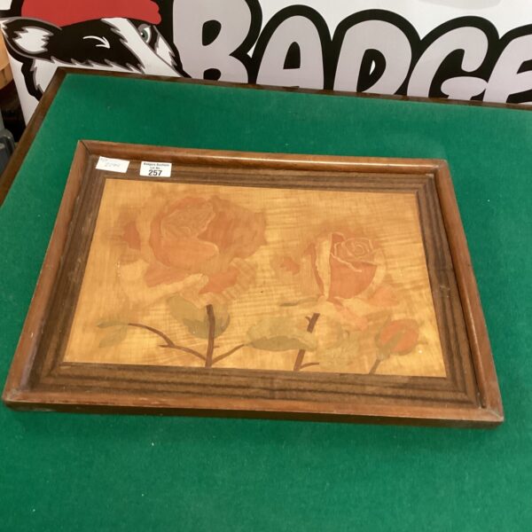 Vintage rose wall plaque with detailed inlaid wood floral design.