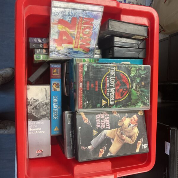 Mixed lot of DVDs, VHS tapes, and a music CD for collectors.