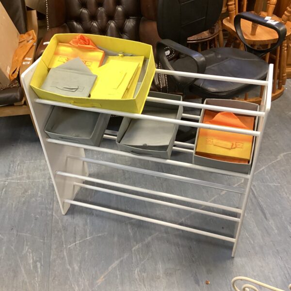 Side view of a modern fabric drawer shelf unit.