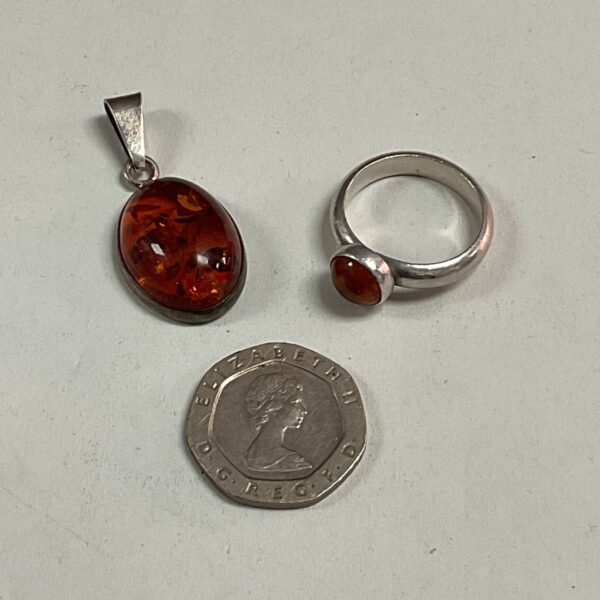 Silver pendant and ring set with amber stone.