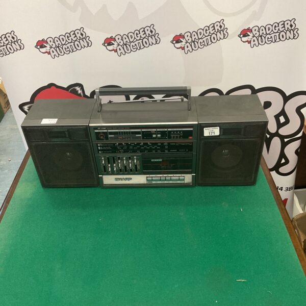 Vintage Sharp portable stereo system with cassette player and radio.