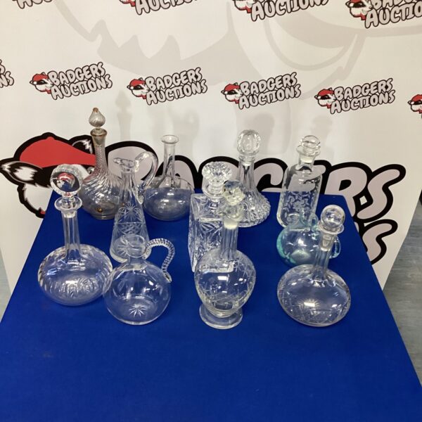 Collection of vintage crystal decanters for serving spirits.
