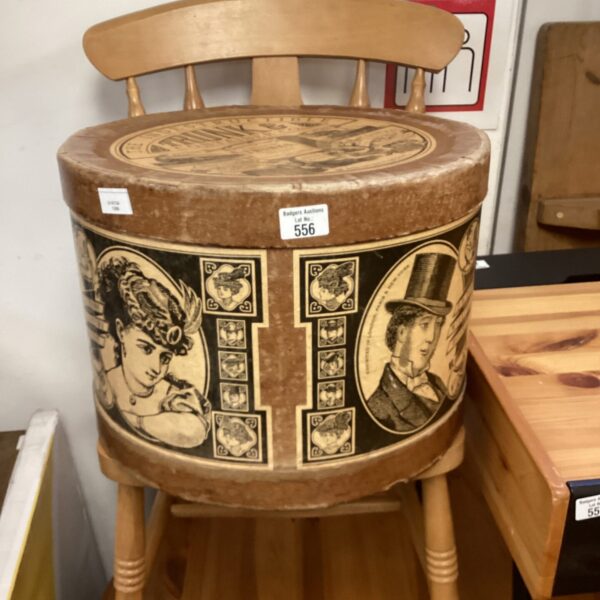 Antique Victorian hat box with a decorative lidded top.