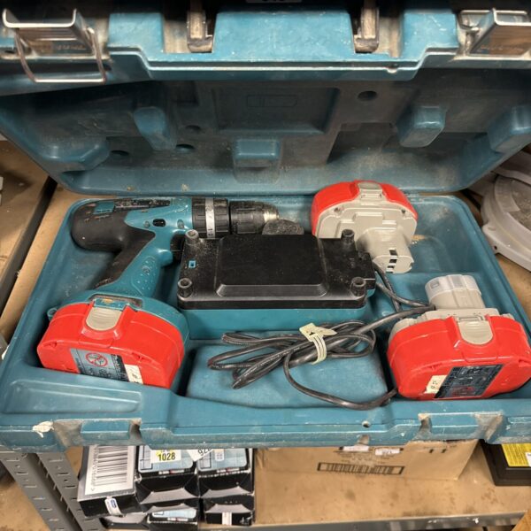 Makita cordless drill with batteries and charger in auction.