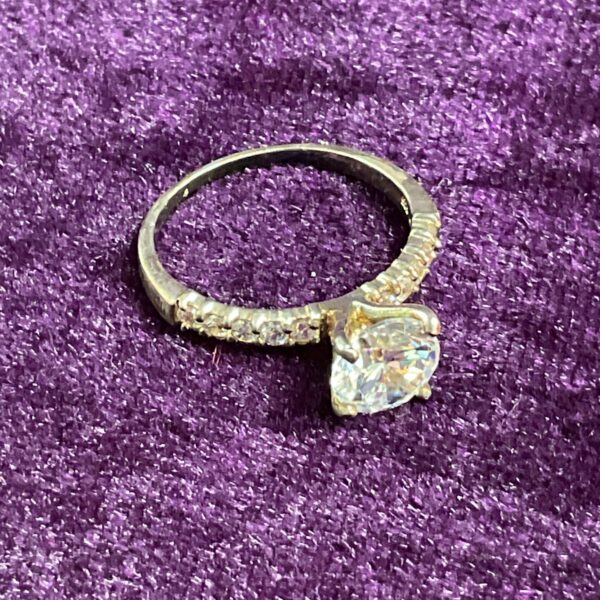 Silver ring with a sparkling cubic zirconia stone, size R.