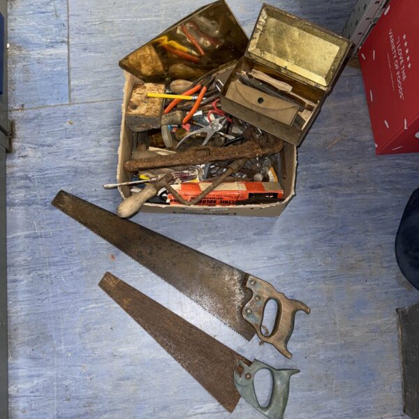 Shed clearance lot with hand tools and saws.