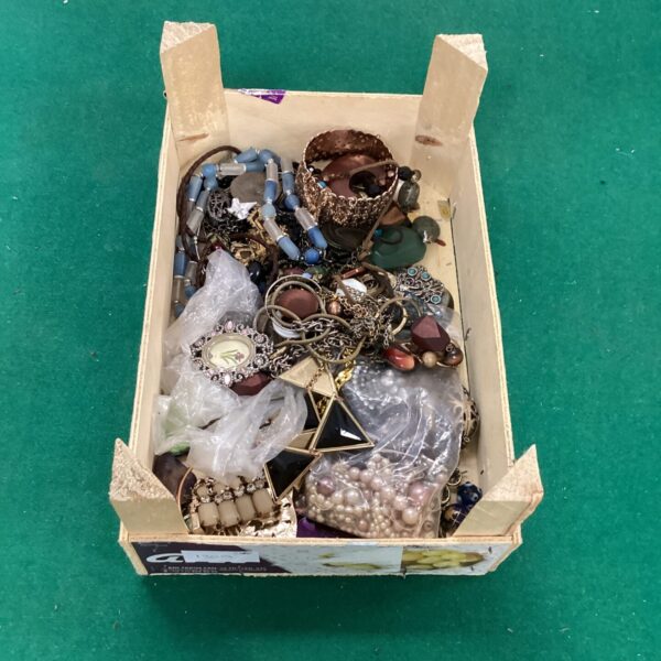 Assortment of vintage costume jewellery including necklaces and brooches.