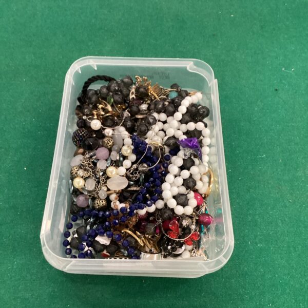 Mixed lot of colourful costume jewellery including necklaces and brooches.