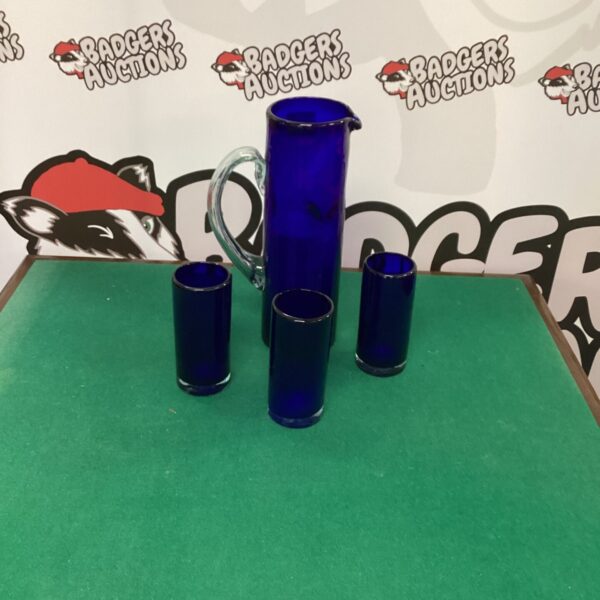 Vintage cobalt blue glass pitcher set with four glasses.