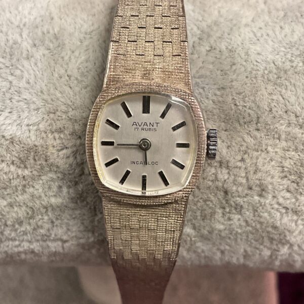 Close-up of vintage silver Avant watch with textured bracelet.