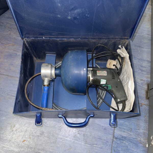 Blue Skil drainage auger in a strongbox for clearing blocked drains.