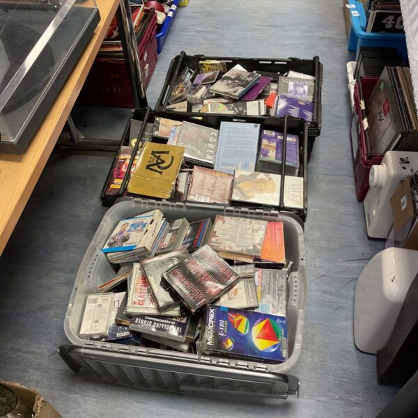 Large lot of music CDs and VHS cassettes in plastic crates.