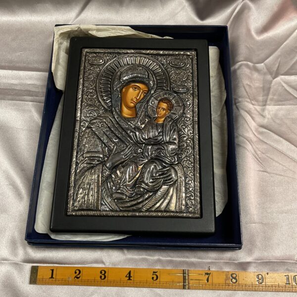 Close-up of 950 silver framed Greek icon depicting Virgin Mary and Christ Child.