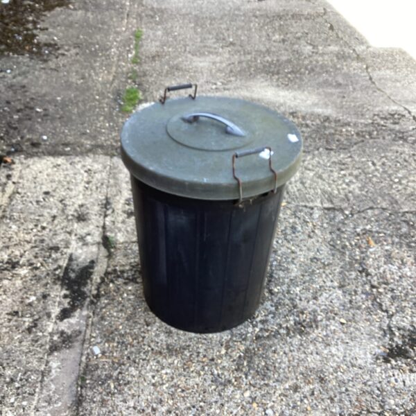 Dark rubberised garden bin for outdoor waste and storage.