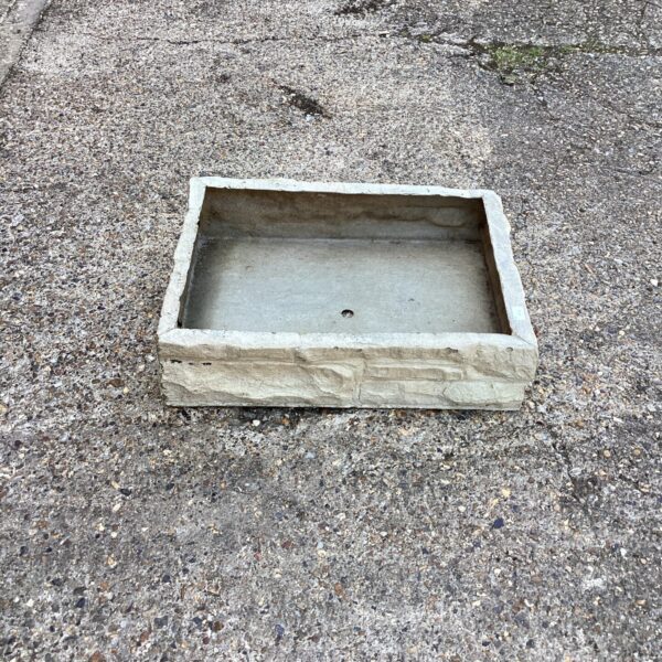Rustic fibre glass garden planter, ideal for outdoor display.