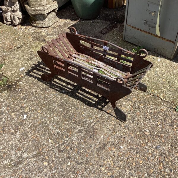 Antique wrought iron fire grate for vintage fireplace decor.