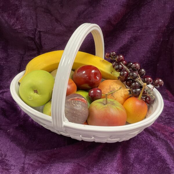 Colourful ceramic fruit basket with woven design, Italian style.