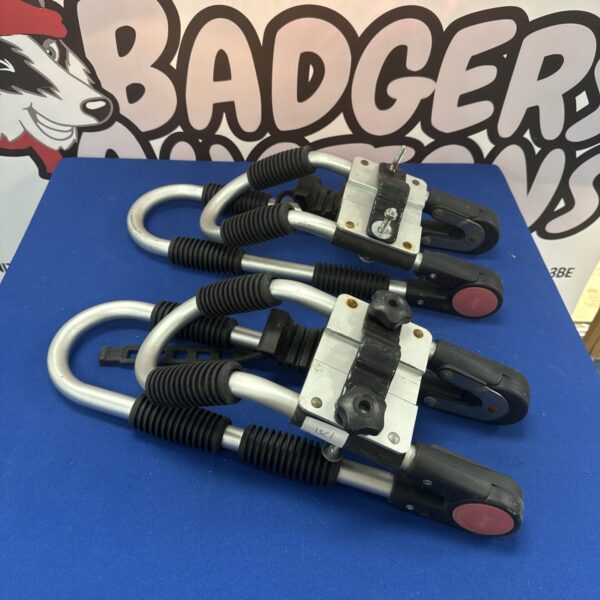 Pair of black kayak roof bars for vehicle transport.