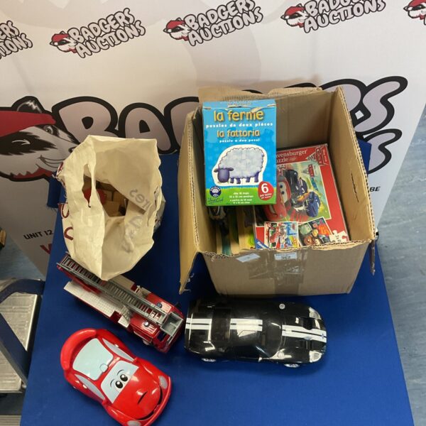 Red toy fire engine and other childrens toys in a bundle.