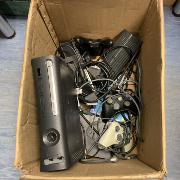 Microsoft Xbox 360 console with controllers and cables.