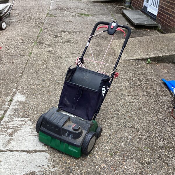 Vintage Qualcast electric lawn scarifier for garden maintenance.