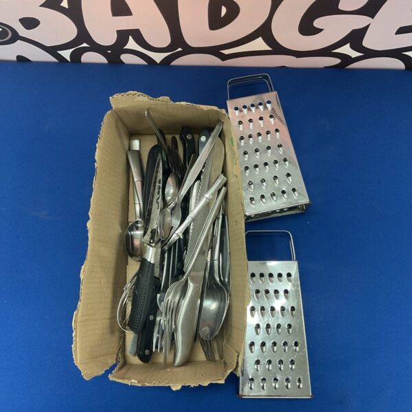 Stainless steel kitchen silverware set displayed in a cardboard box.