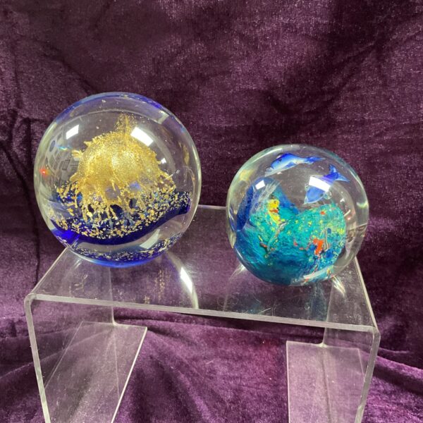 Clear glass paperweight with sculpted dolphins and jellyfish.