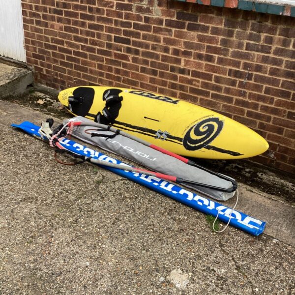 Vintage Clzlzi windsurf board with sail for watersports enthusiasts.