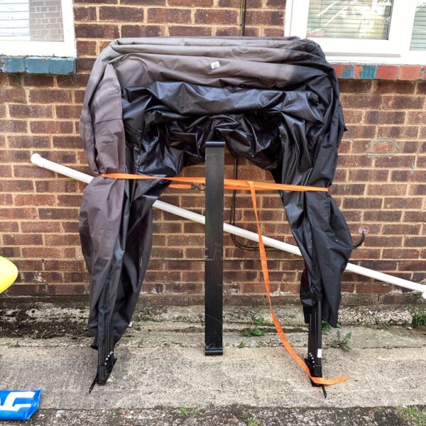 Grey folding motorbike garage for outdoor motorcycle storage.