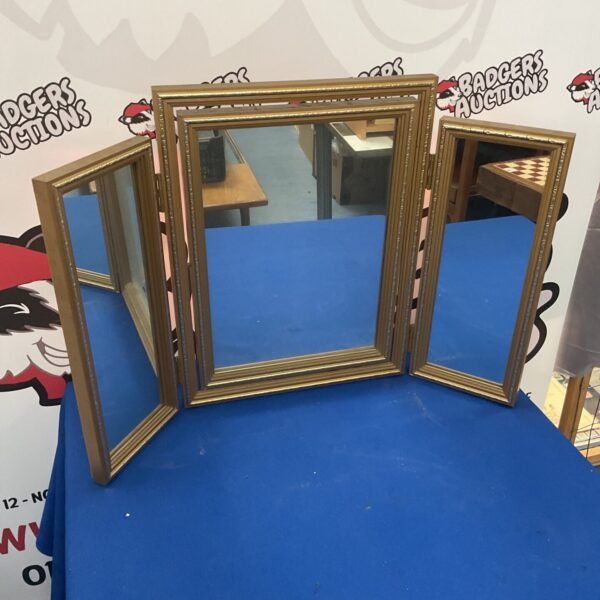 Vintage three-panel folding dressing table mirror with wooden frame.