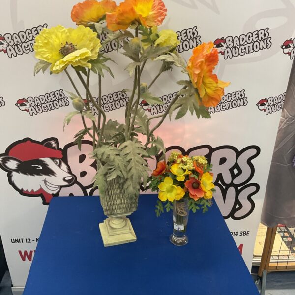 Vibrant artificial flower arrangement in a clear glass vase.
