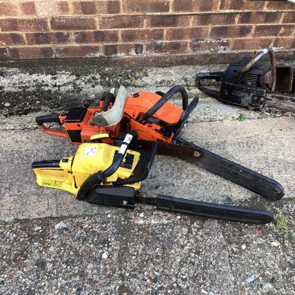Vintage petrol chainsaw offered as part of a lot.