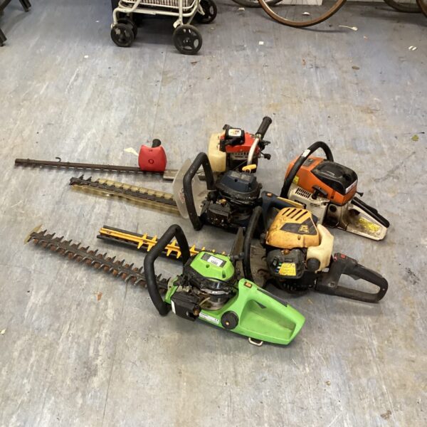 Lot of five used petrol hedge trimmers for garden maintenance.