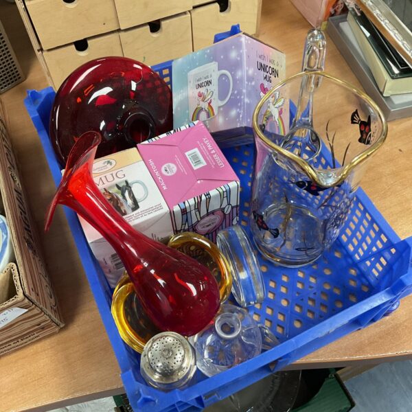 Assorted glassware and a horse unicorn mug on a tray.