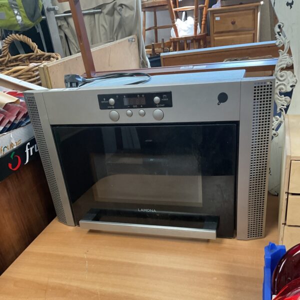 Silver Lamona microwave oven on a countertop.