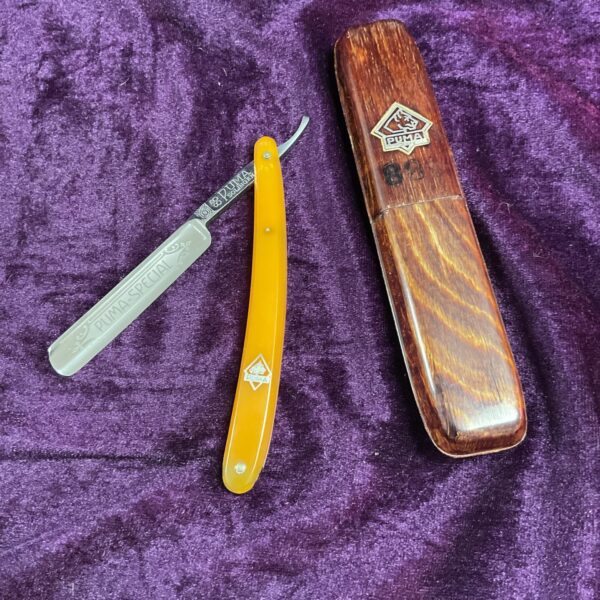 Vintage Puma Special cut throat razor with yellow handle.